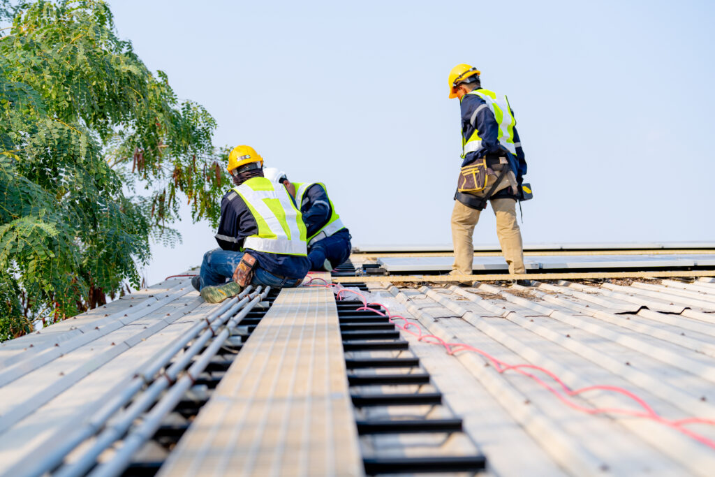 workers installing solar panels, for efficient energy on rooftop