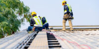 workers installing solar panels, for efficient energy on rooftop